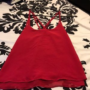 A sleeveless burgundy shirt